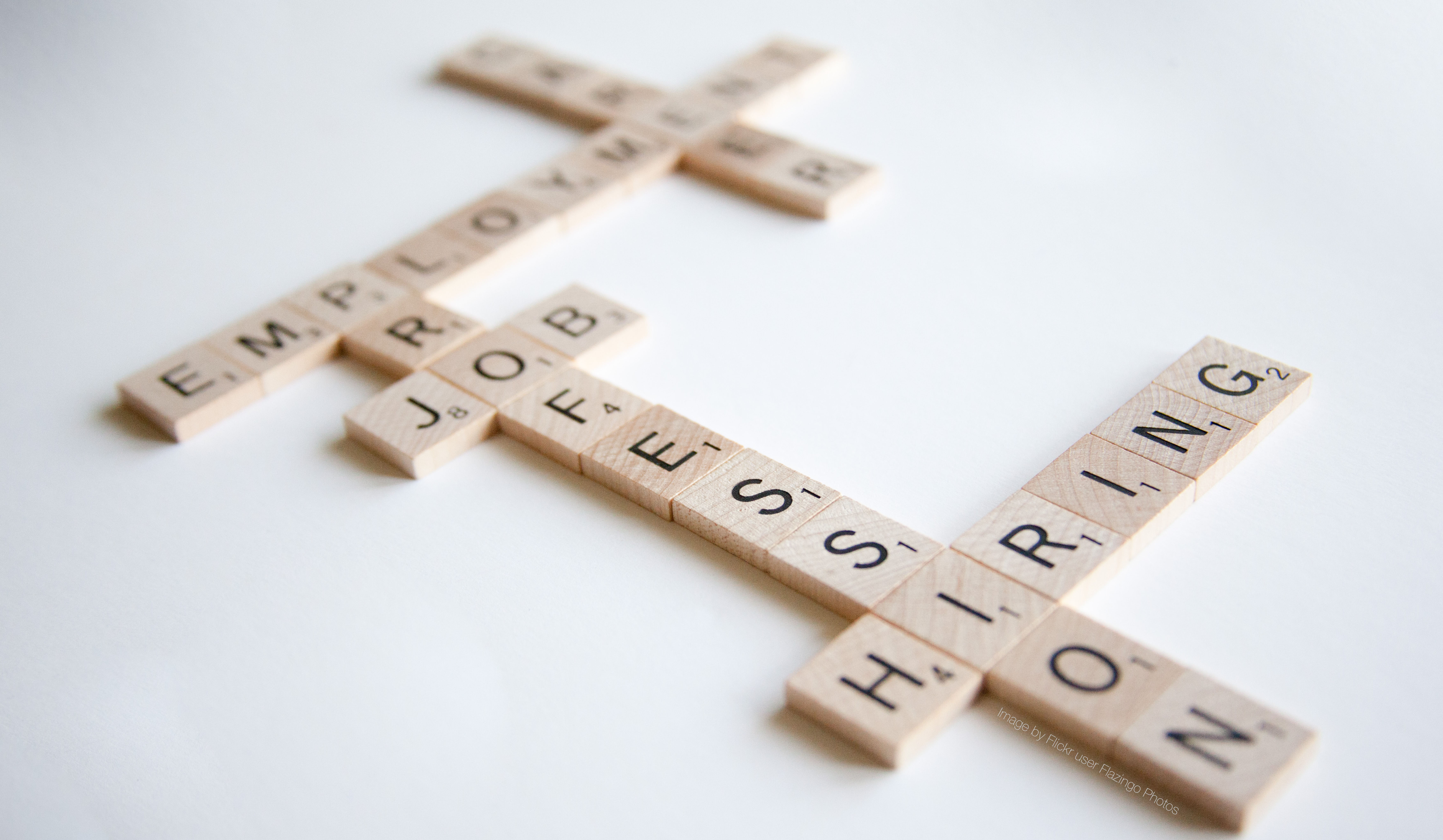 A scrabble game with words relating to employment.