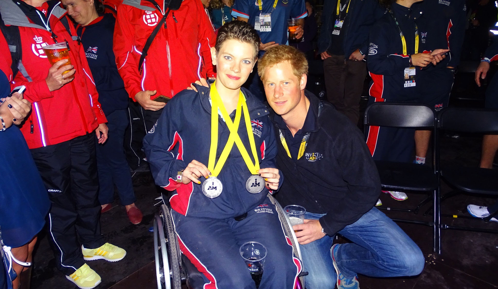 Susan Cook with Prince Harry, holding her silver medals.