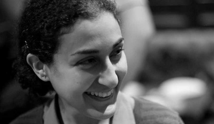 A black and white portrait of Mary Yacoob smiling into the distance 
