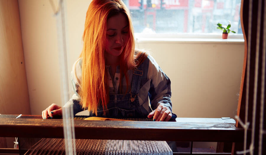 Photo of Claire Whelan at a loom