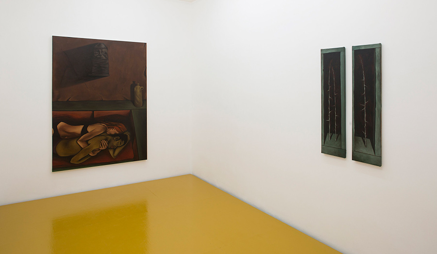 A gallery room with two paintings on white walls and a yellow painted floor