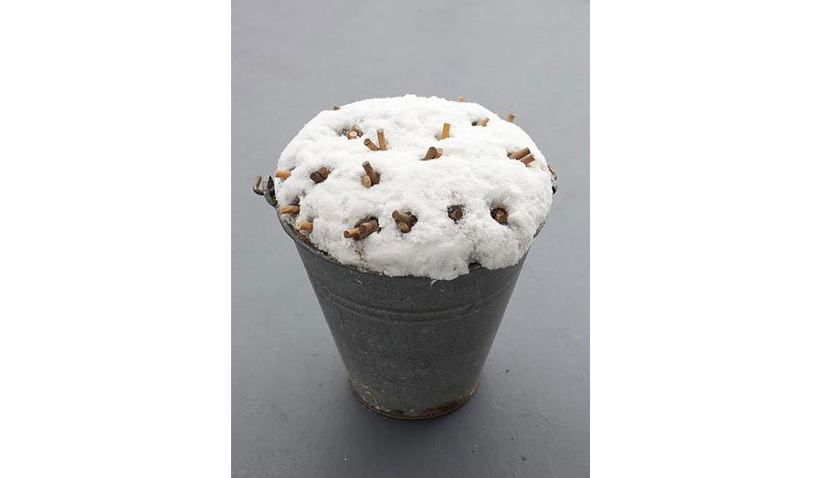 a bucket of snow with cigarette butts in
