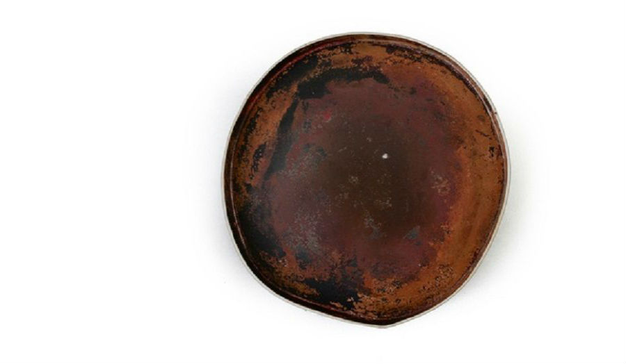 A very old-looking copper enamel bowl