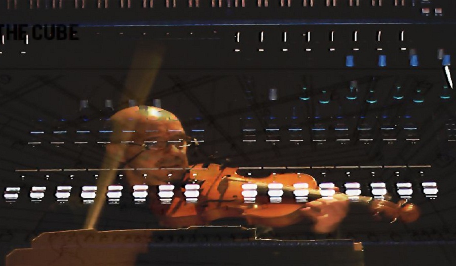 A sound board with a superimposed, translucent image of a man playing the violin over the top