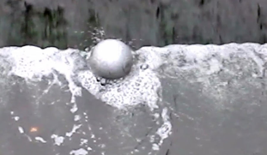 Photograph of a ball in water, part of the artwork by Oliver Hickmet.