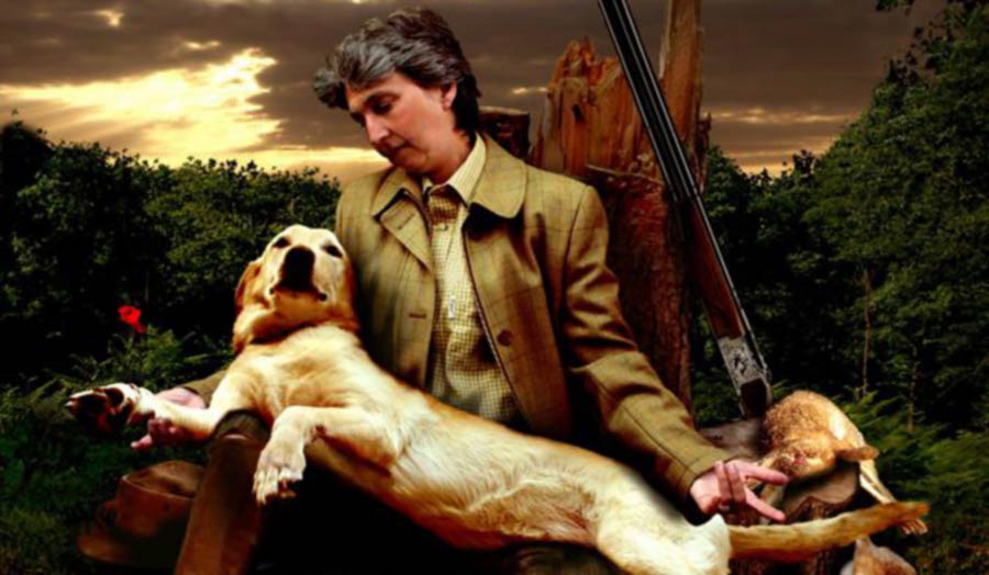 Image by Mary-Jane Opie showing man in hunting jacket with dog on lap