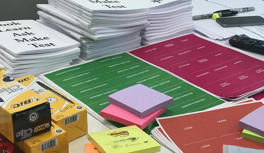A pile of booklets, post-it notes and other writing material 