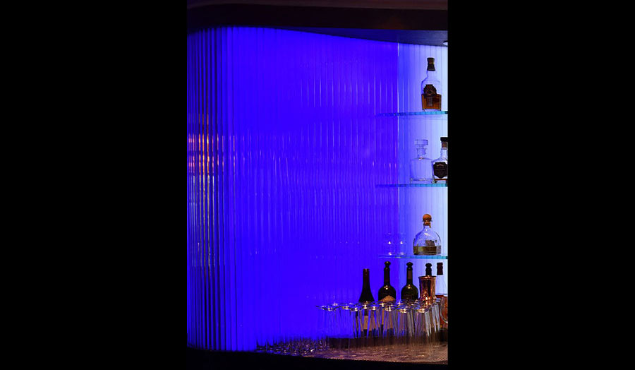 Glass bottles and glasses displayed on a blue background