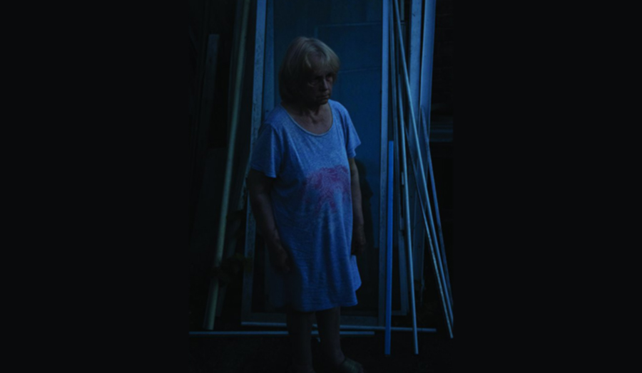 Woman standing in a dark bluish place