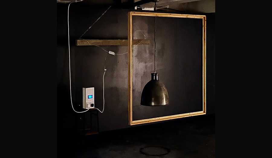 A photo composition using a photo frame, pendant lamp, and a switch with cables plugged in