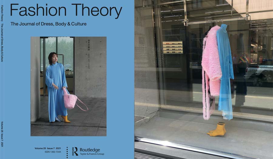 Cover of Fashion Theory next to a clothing shop window