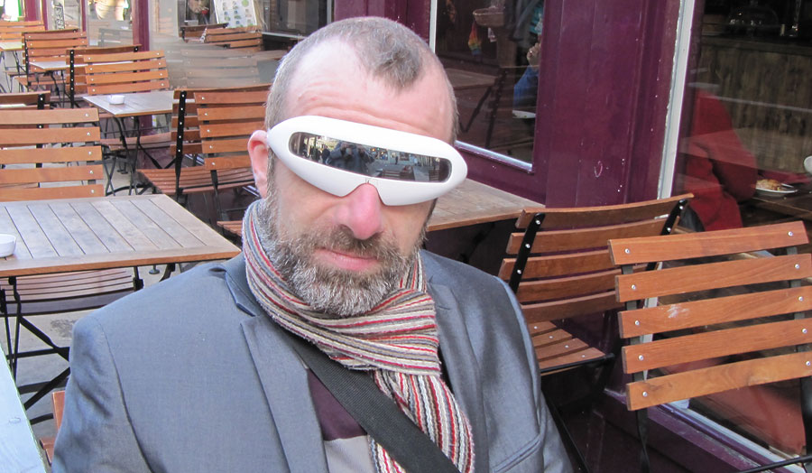 Man sitting on a terrace wearing a pair of glasses
