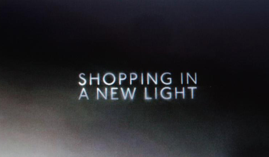 The words, "Shopping in a new light" against a plain black background.