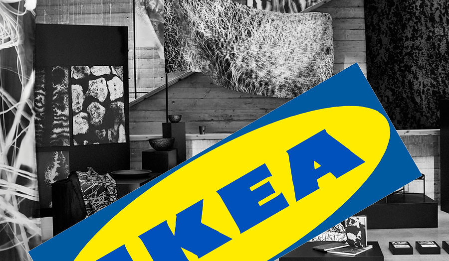 Black and white photograph of furniture with the blue and yellow IKEA logo on top of it.