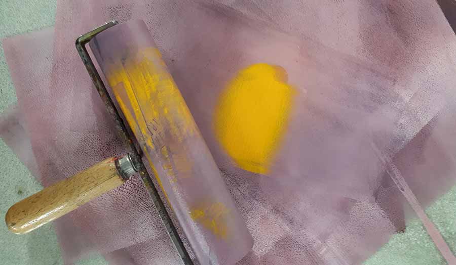 Roller and yellow paint