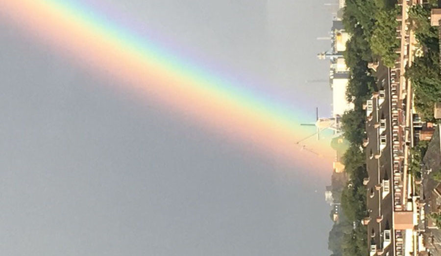 Sideway rainbow over city