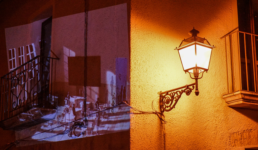 Film projected onto building with street lamp