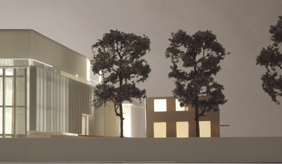 white model of building with three trees
