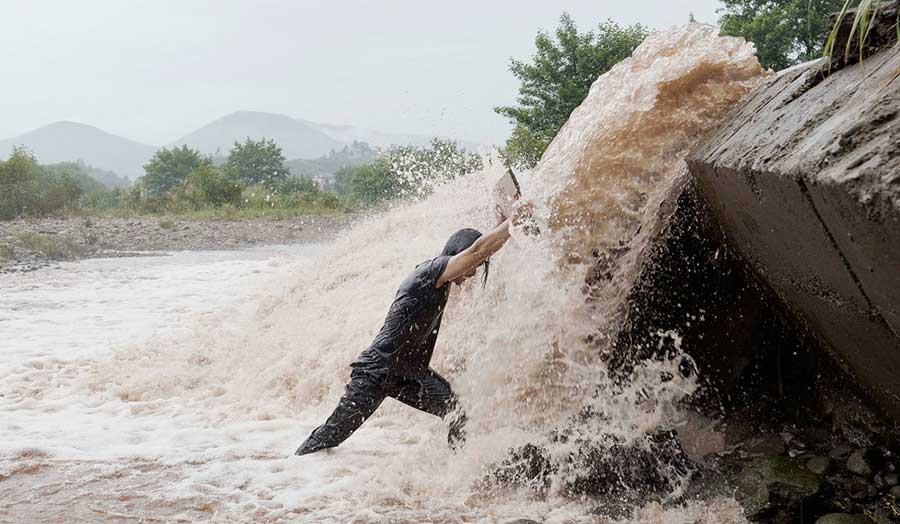 A man under a cascade of water