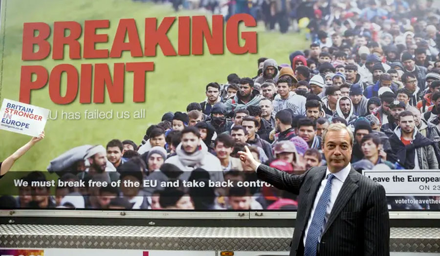 Farage pointing to his campaign poster