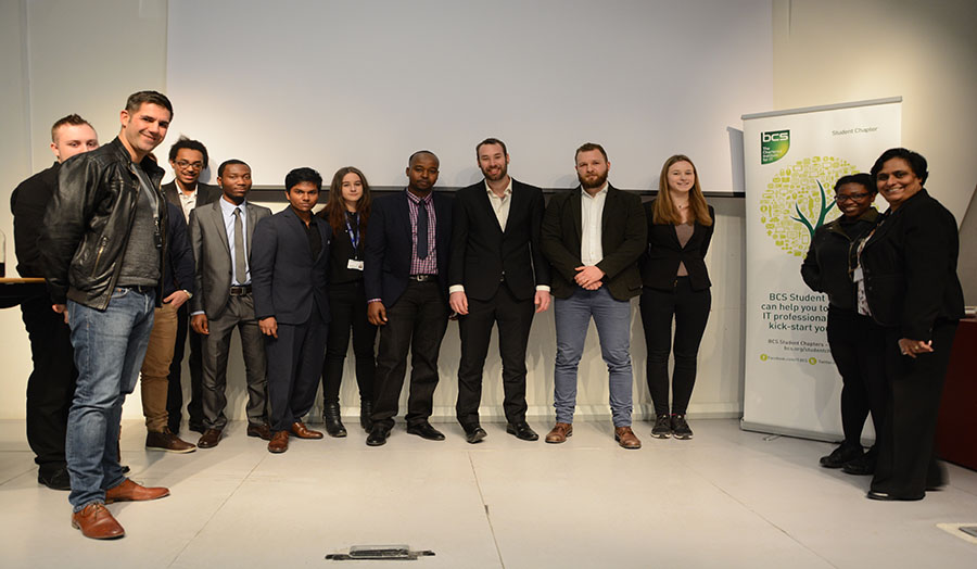 Photograph of students and speakers from the event.