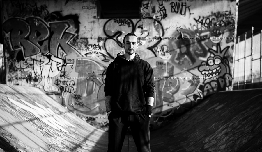 James pictured standing with graffiti behind him