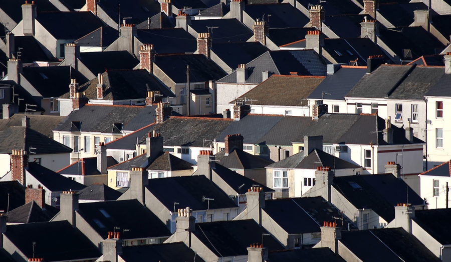 striking landscape shot of large housing estate with lots of rooftops and chimneys