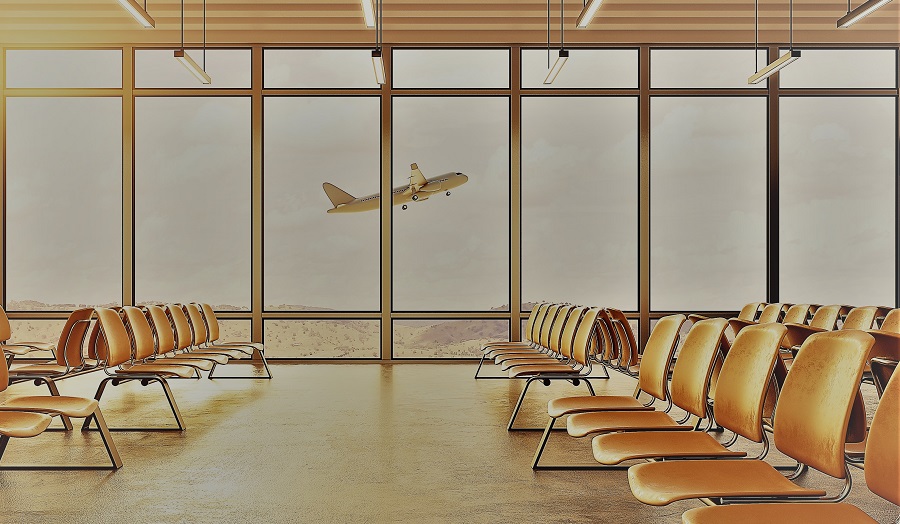 An airport waiting lounge, with a plane viewed through the windows