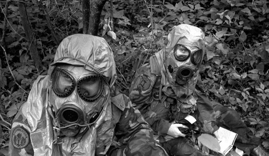 two people wearing gas masks