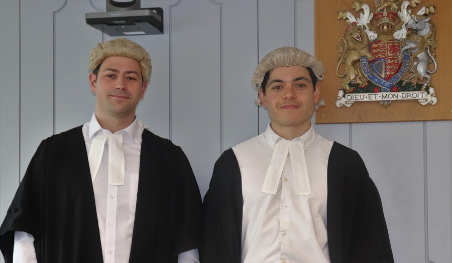 Two male students wearing barrister's robes and wigs