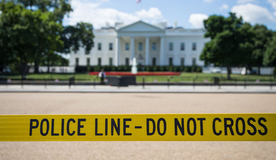 White House in background, with yellow police tape in foreground