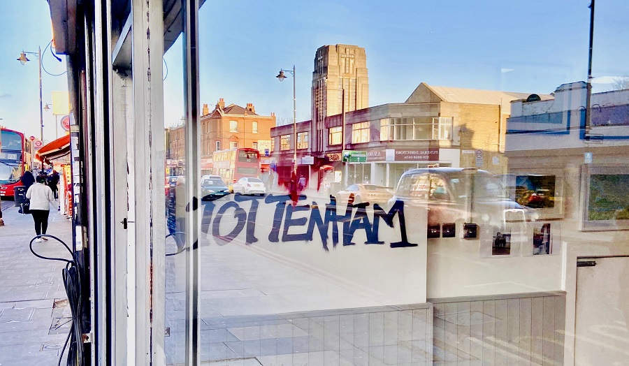 graffiti reading 'I love Tottenham' seen through a shop window