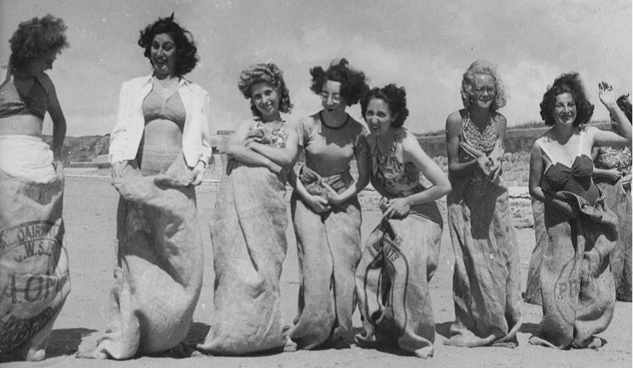 An archival image of the Brady Girls taking part in a sack race 