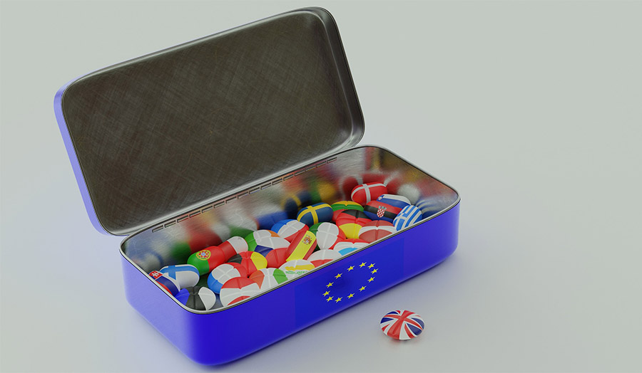 Image of European flag pins in a box with the EU logo, with the British pin lying outside the box