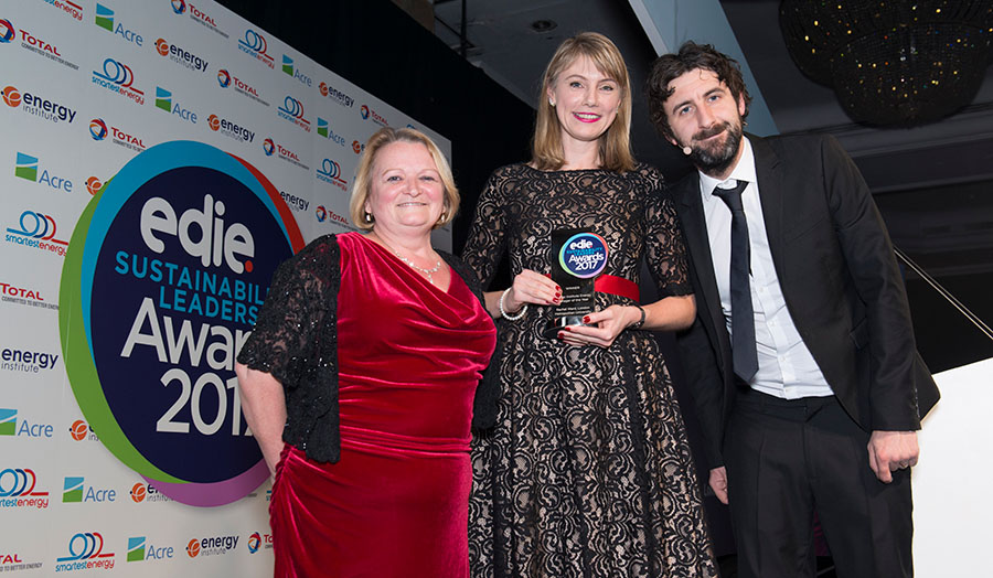 Image of Rachel collecting her award with capability director Sarah Beacock and compere Mark Watson