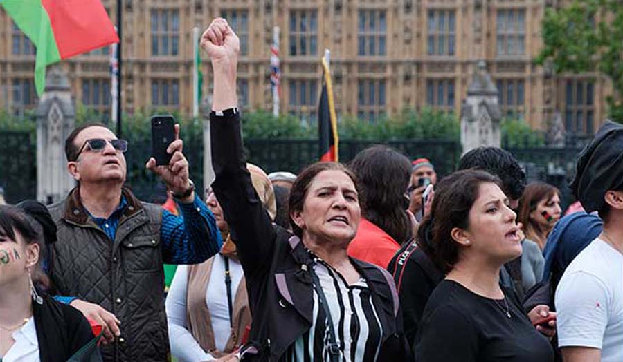 A group of Afghan migrants protesting outside parliament.
