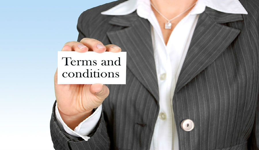 Picture of a woman holding a card that reads, "Terms and conditions"