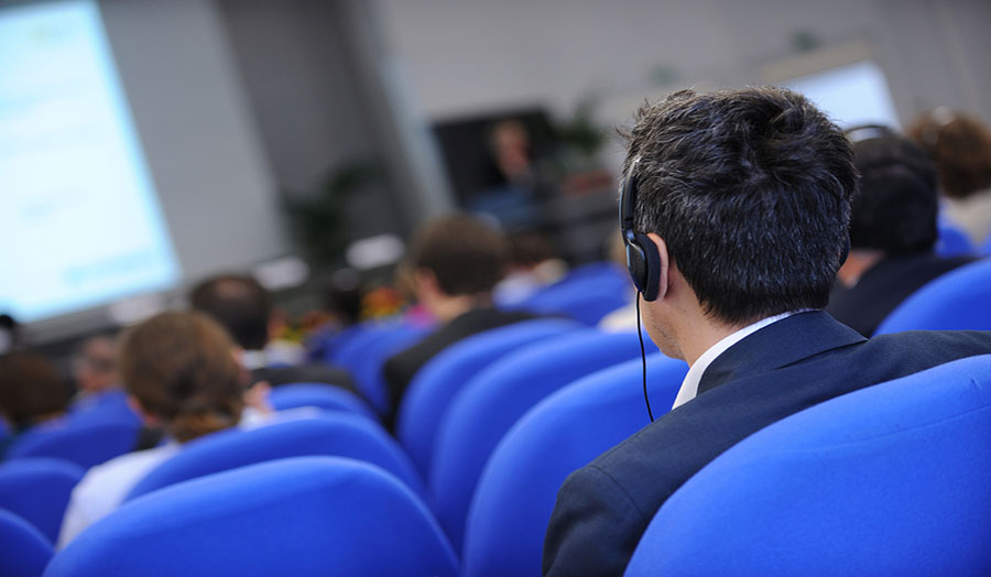 Man in conference with headphones for translation