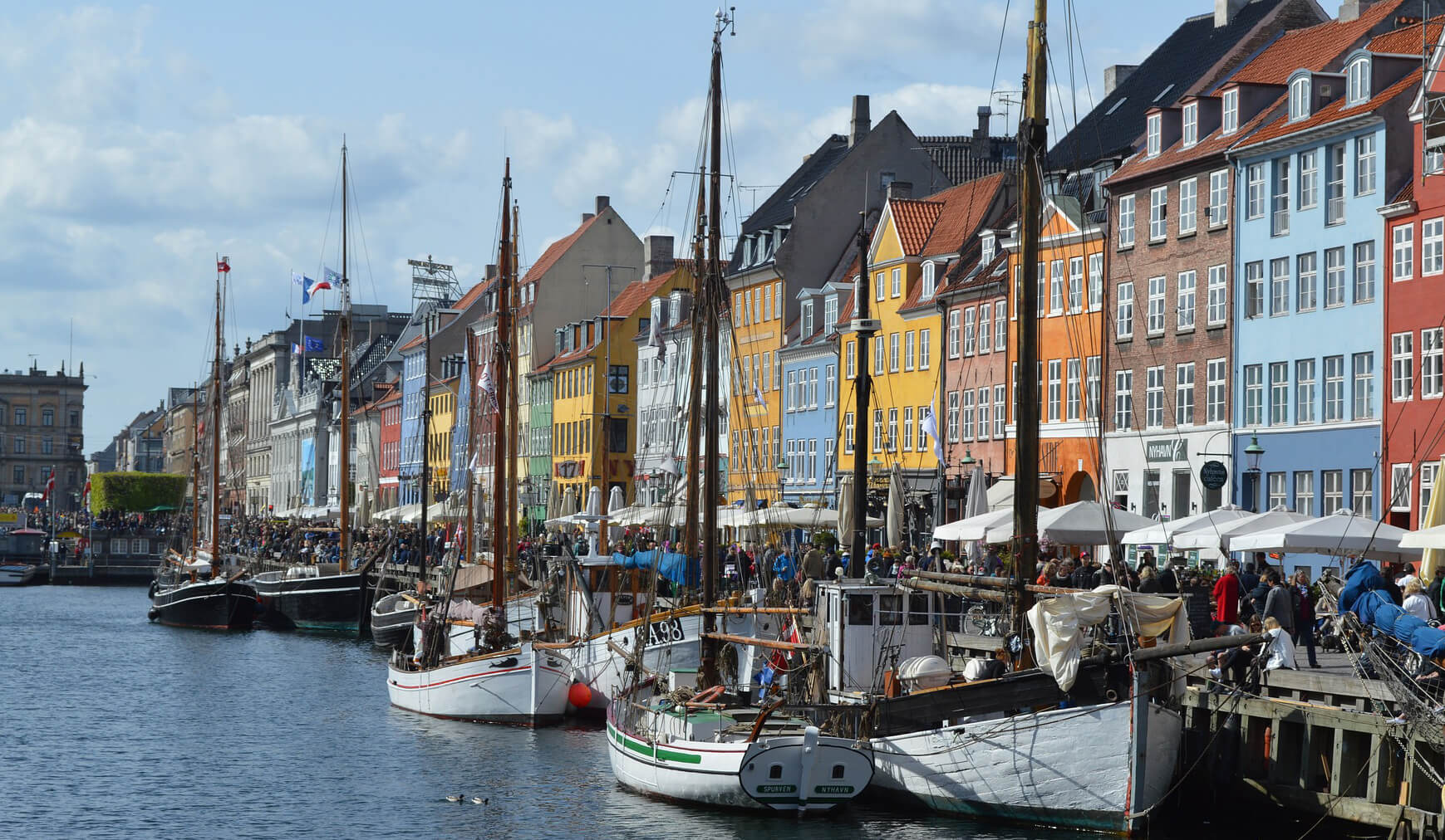 View of Copenhagen houses across a river with boats