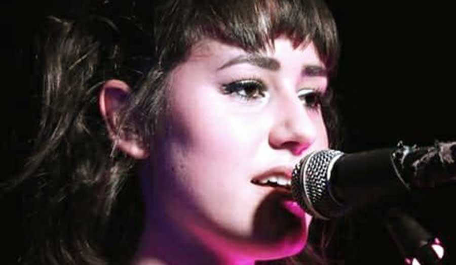 close up headshot of Jasmine Damaris singing