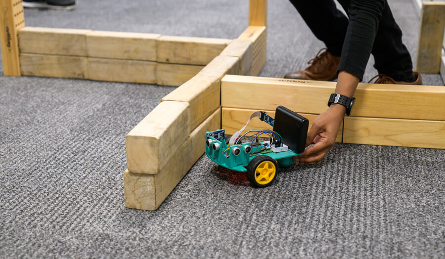 Student placing his robot in the test maze