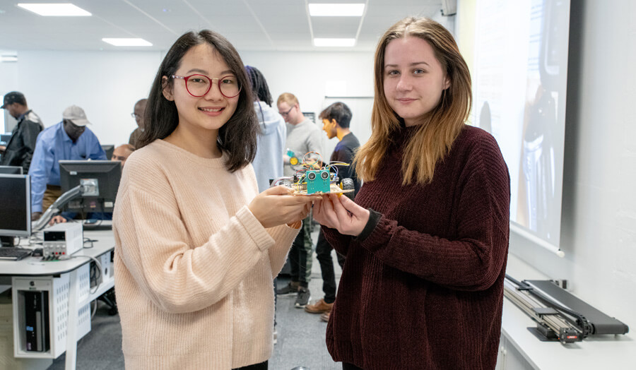 Pair of female students with their robots