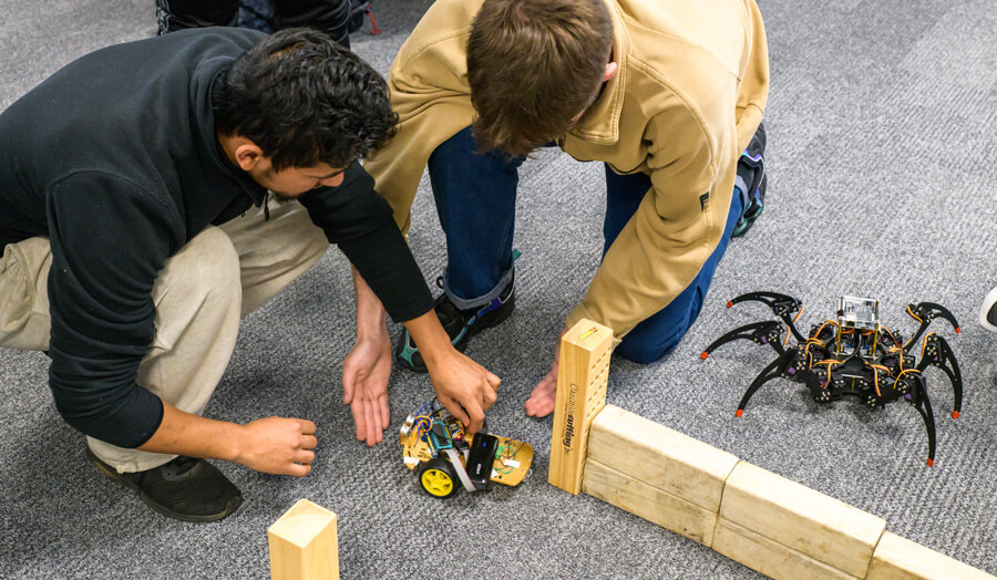 Students placing their robots in the maze