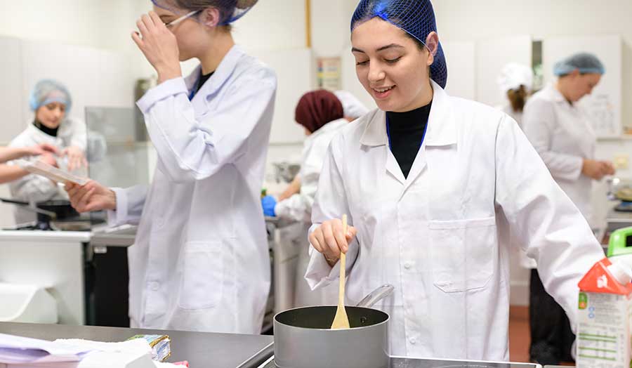 a female student stirring her cooking