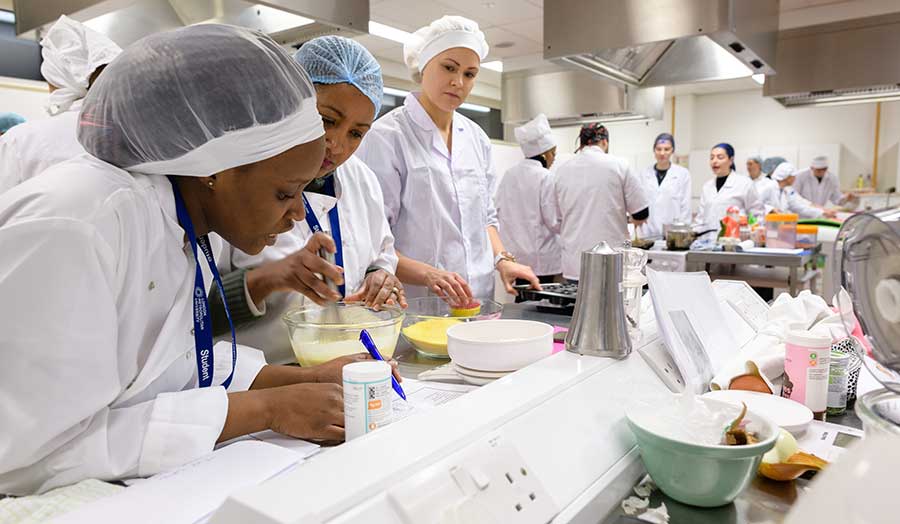 students recording their work during a practical kitchen project