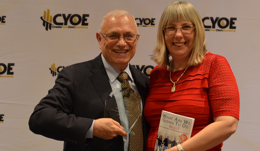 Catherine Skeggs receiving Team Building Coach award from Raymond Aaron.jpg