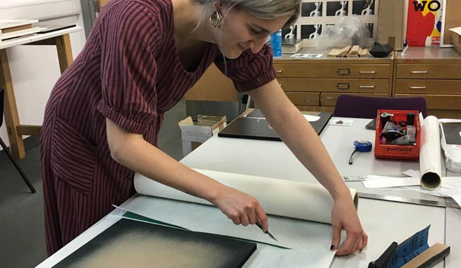 A student preparing work for exhibition