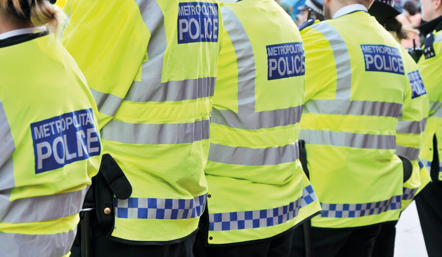 Back of police officers high visibility jackets