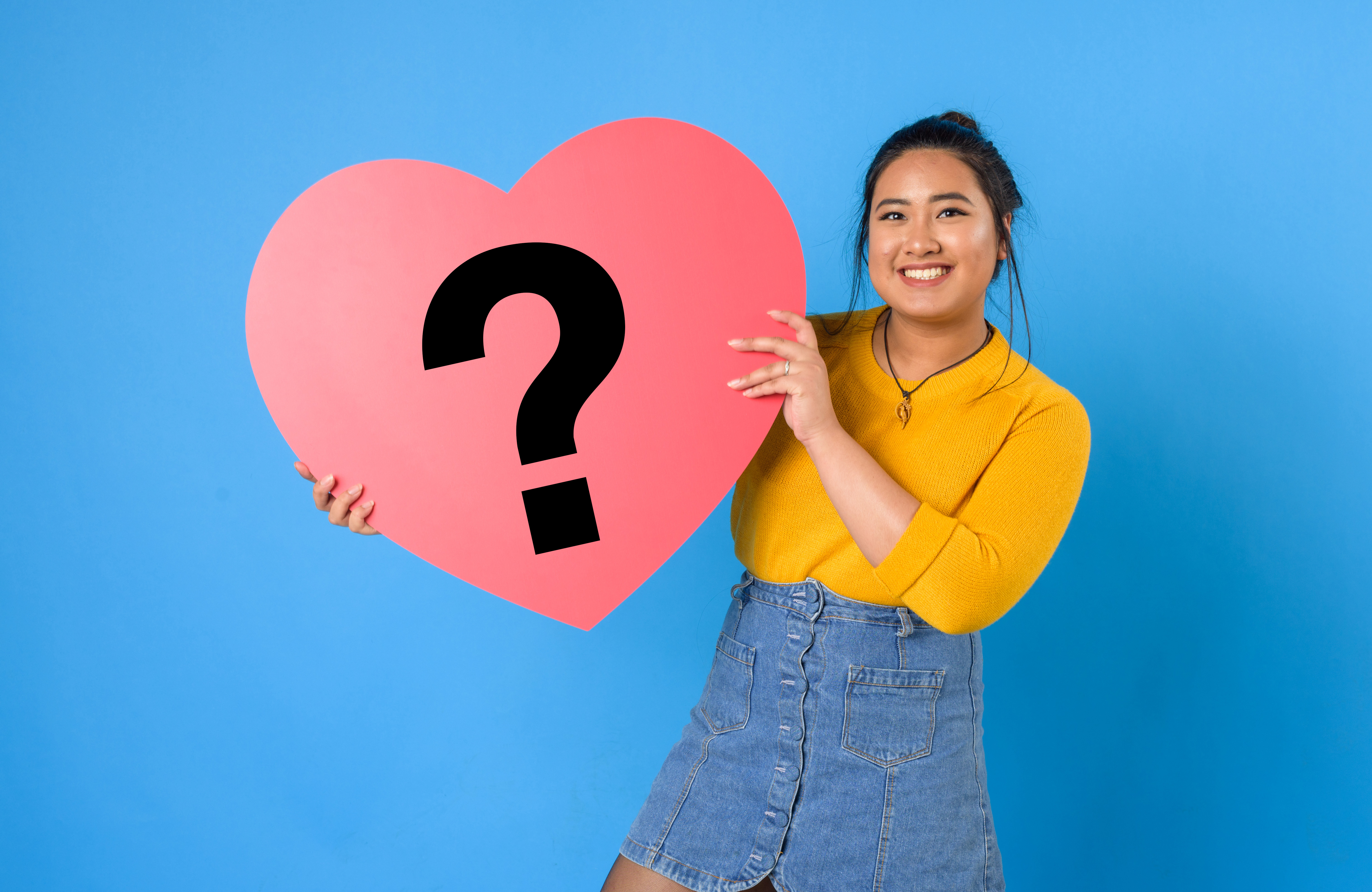 Student holding a heart with a question mark in it.