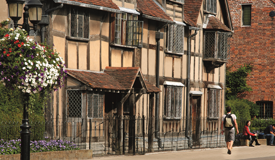 Man walking down old fashioned Stratford Upon Avon street